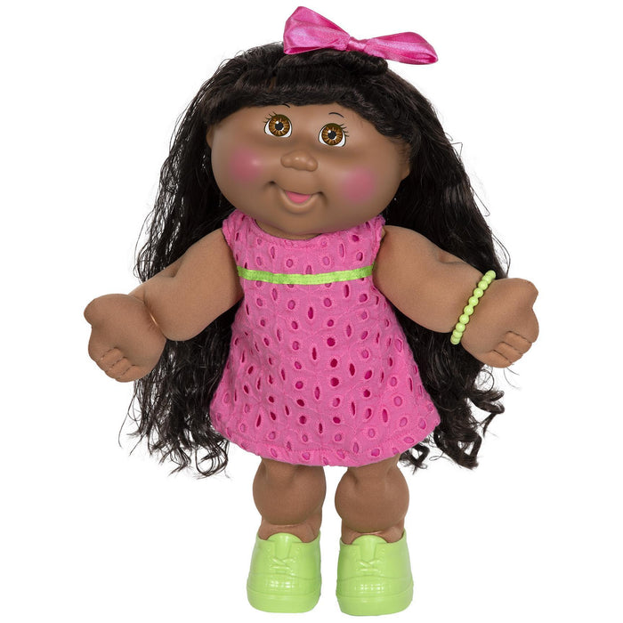 A 14-inch Cabbage Patch Kid doll with dark skin and black hair, wearing a pink summer dress and green shoes.