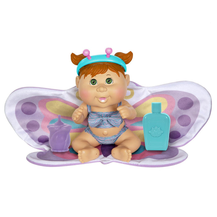 A 9-inch doll with red hair and green eyes, wearing a blue outfit and butterfly wings, accompanied by a butterfly towel and a baby bottle.