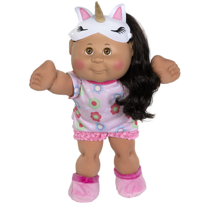 A 14-inch Cabbage Patch Kid doll with black hair, wearing a pink outfit with floral patterns and a unicorn-themed sleep mask, standing upright.