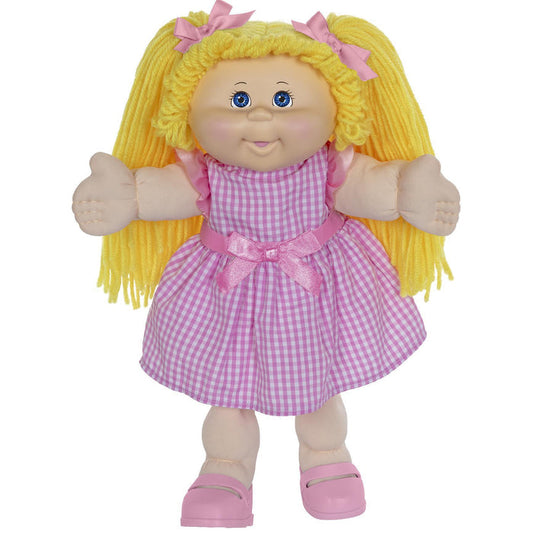 A 16-inch doll with blonde hair and blue eyes, wearing a pink checkered outfit and pink shoes.