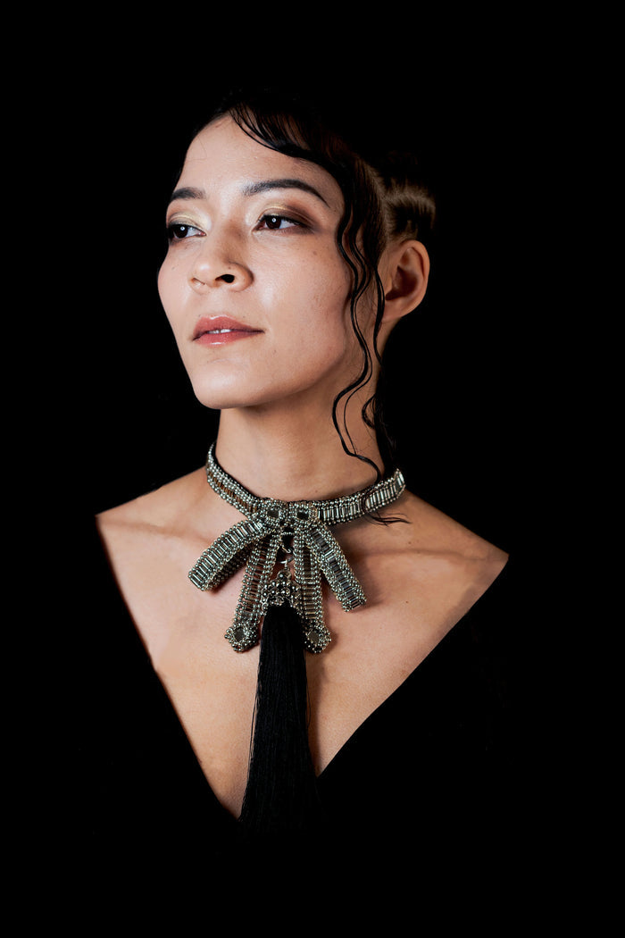 beaded bow modular choker silver by object and dawn worn by woman in black outfit