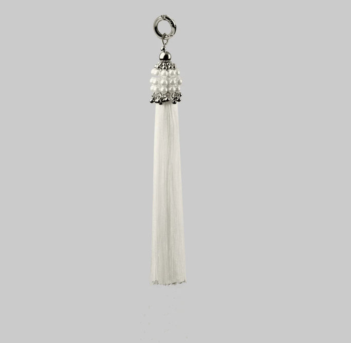 Beaded handcrafted polyester tassel by silver coated metal beads with systethic japanese pearl on grey background