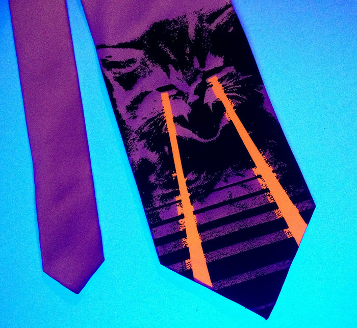 Black and glow red on pink in blacklight.
