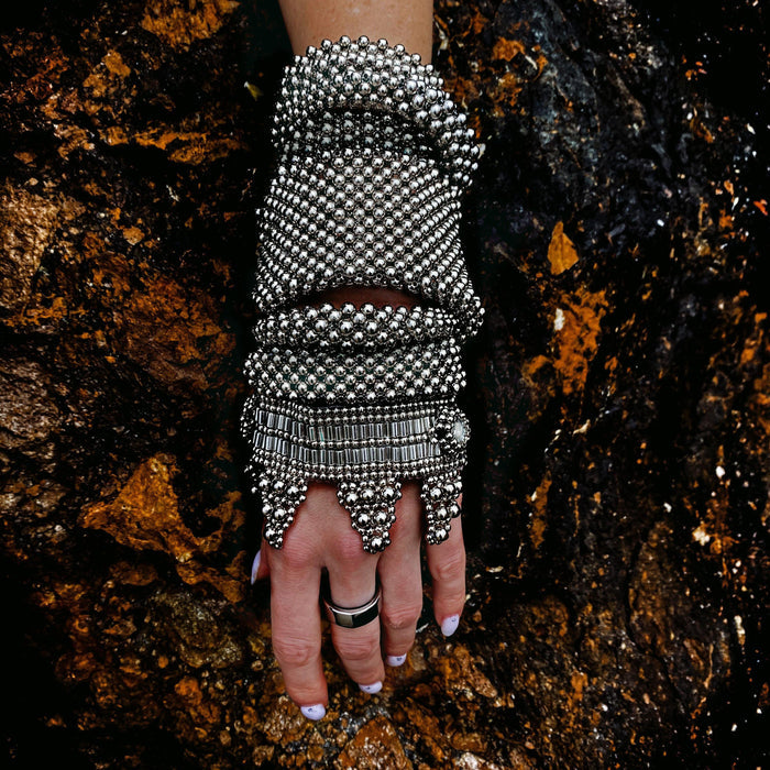 Object & Dawn beaded wrist accessory in ivory, structured supple cuff with polymer metal beads, ghost image