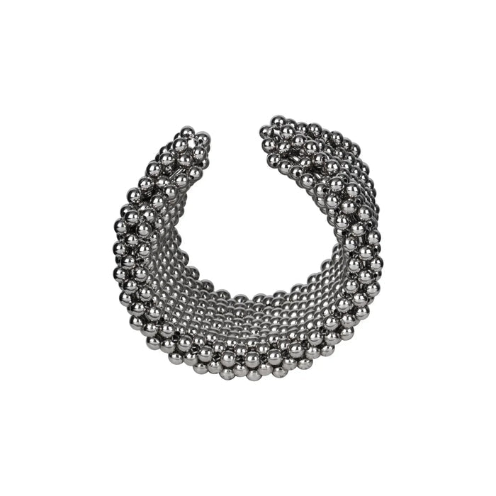 Object & Dawn beaded wrist accessory in ivory, structured supple cuff with polymer metal beads, ghost image diagonal view