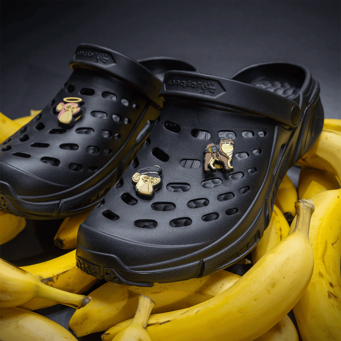 Bored Apes Popinz 3 Pack on black trekking clogs on top of a stack of bananas