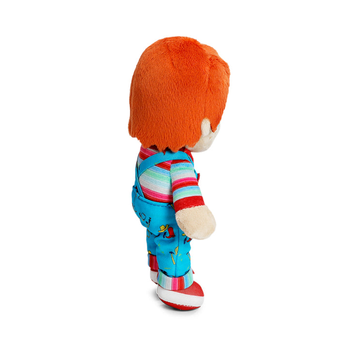 Child's Play 2 Chucky plush toy standing in box, soft Good Guy doll from the horror film series, by Chucky.
