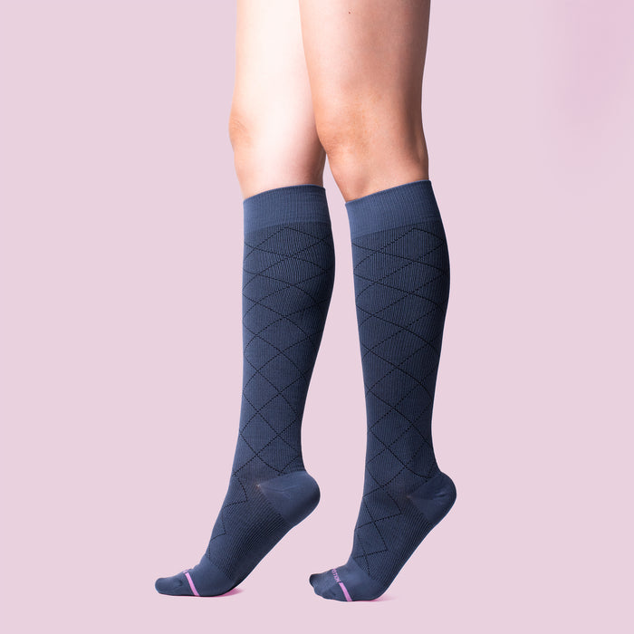 Knee-high compression socks with a diamond pattern in dark blue and pink accents.