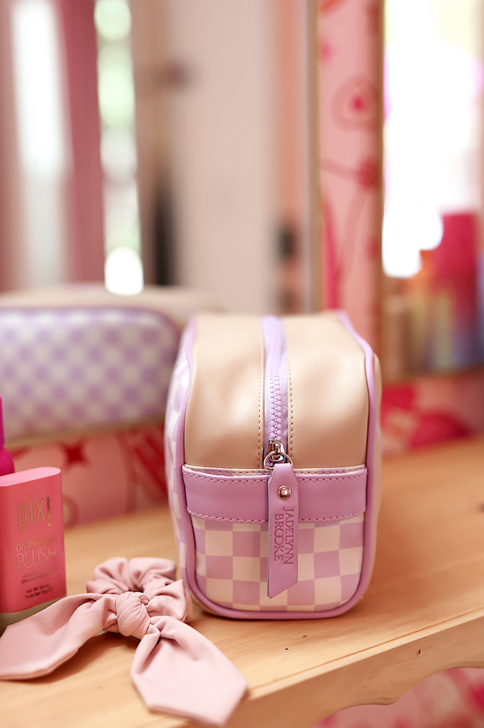 Purple checkered cosmetic bag with beige accents, zip closure, perfect for makeup and travel essentials.
