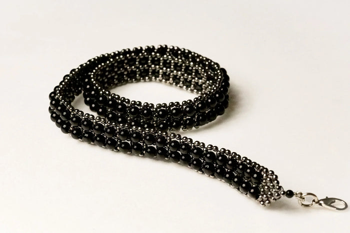 beaded modular hat band for hat accecories by object and dawn in white background close up logo view