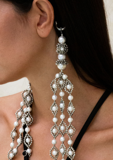 close-up of model wearing crystal and pearl embellished trinity medallions by object and dawn with intricate beadwork