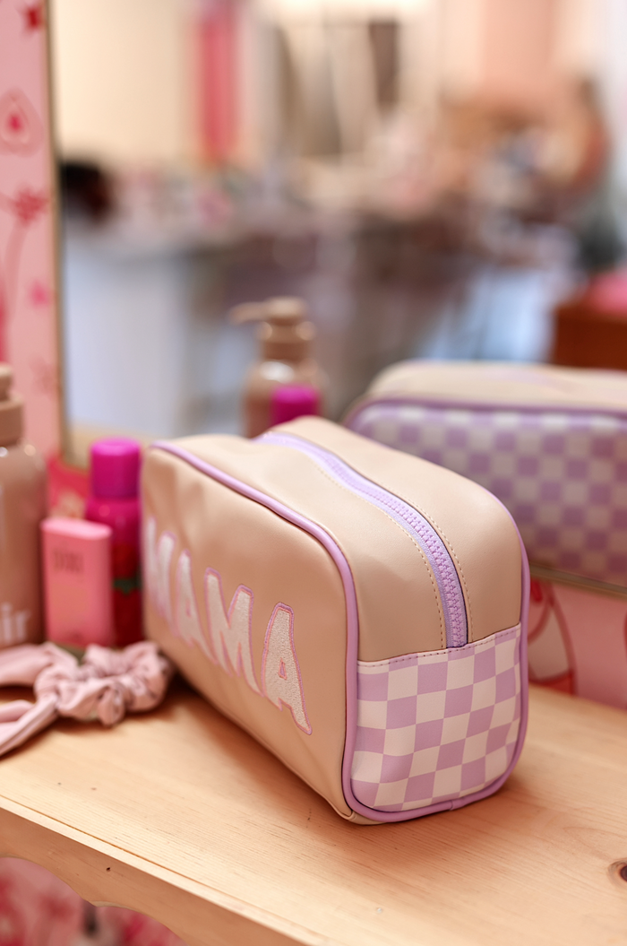 Blush pink faux leather makeup bag with 'MAMA' embroidery and purple checkered side design.
