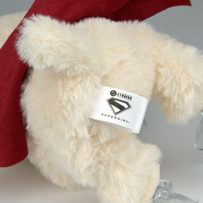 Supergirl Krypto plush window clinger featuring Supergirl logo and vibrant colors, designed for decorative display on windows.